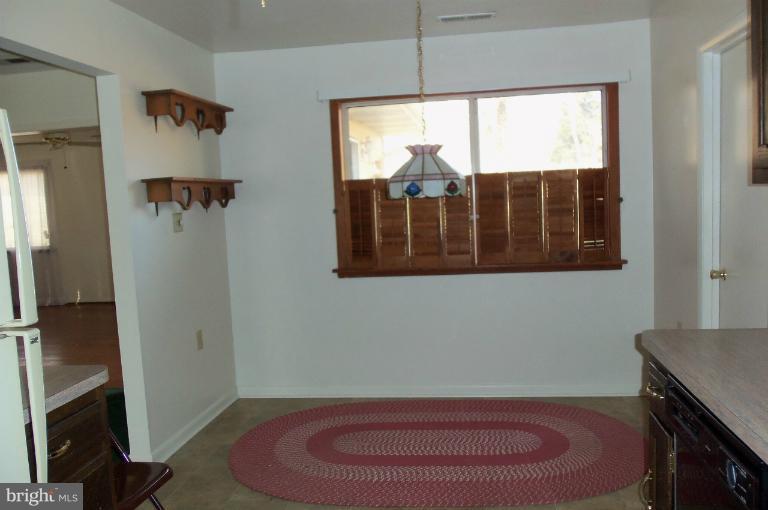 977 Grace Road Huntingtown, MD 20639 - Photo 5 of 14 a view of a room with a hardwood floor and a ceiling fan