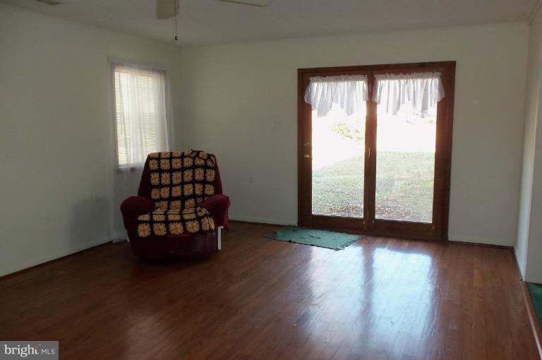 977 Grace Road Huntingtown, MD 20639 - Photo 6 of 14 an empty room with wooden floor and windows