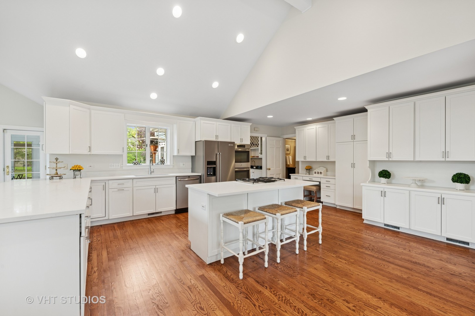 11 Longmeadow Road Winnetka, IL 60093 - Photo 7 of 31 a kitchen with white cabinets and stainless steel appliances