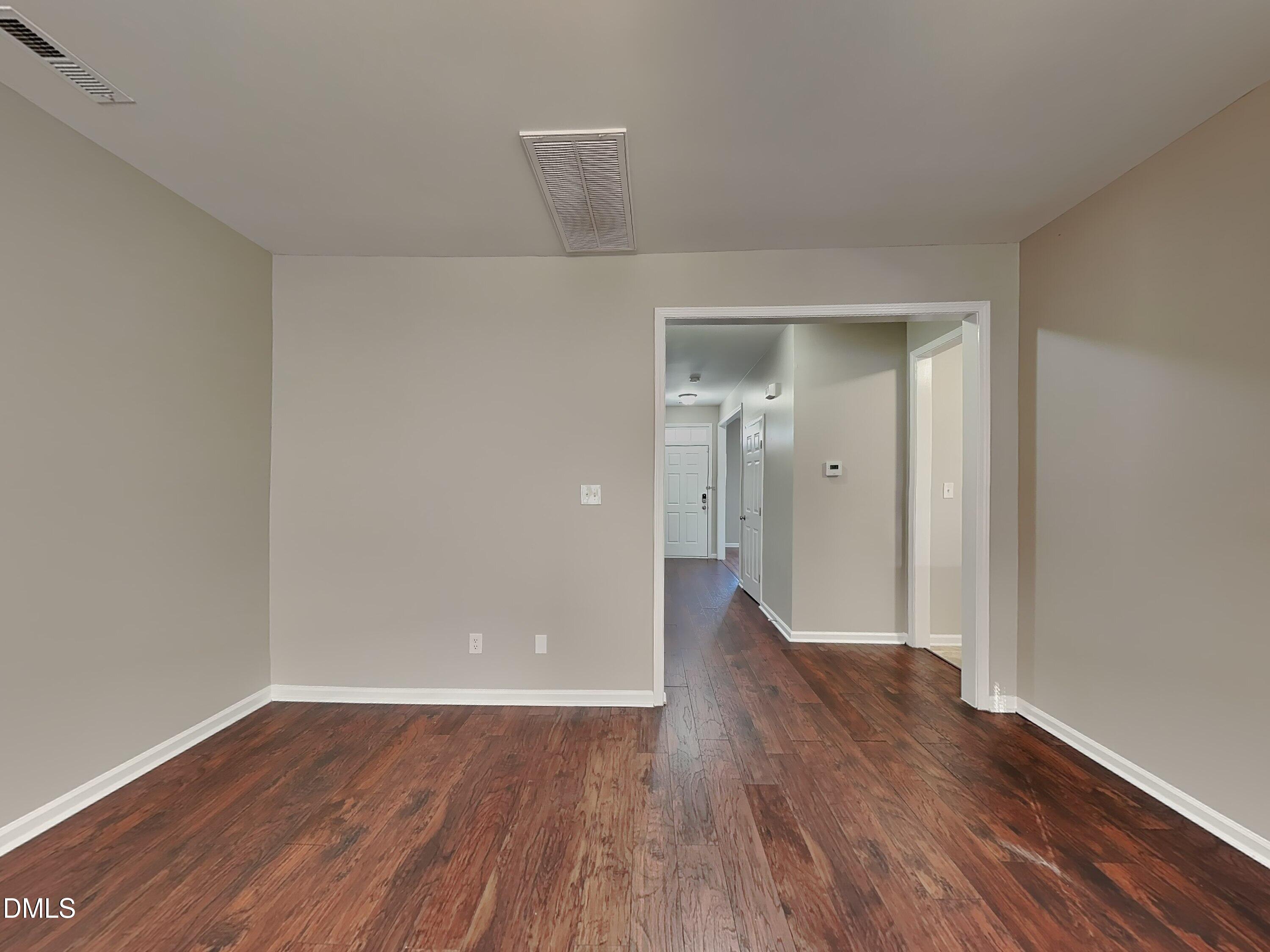4053 Laurel Glen Drive Raleigh, NC 27610 - Photo 2 of 20 a view of a hallway with wooden floor