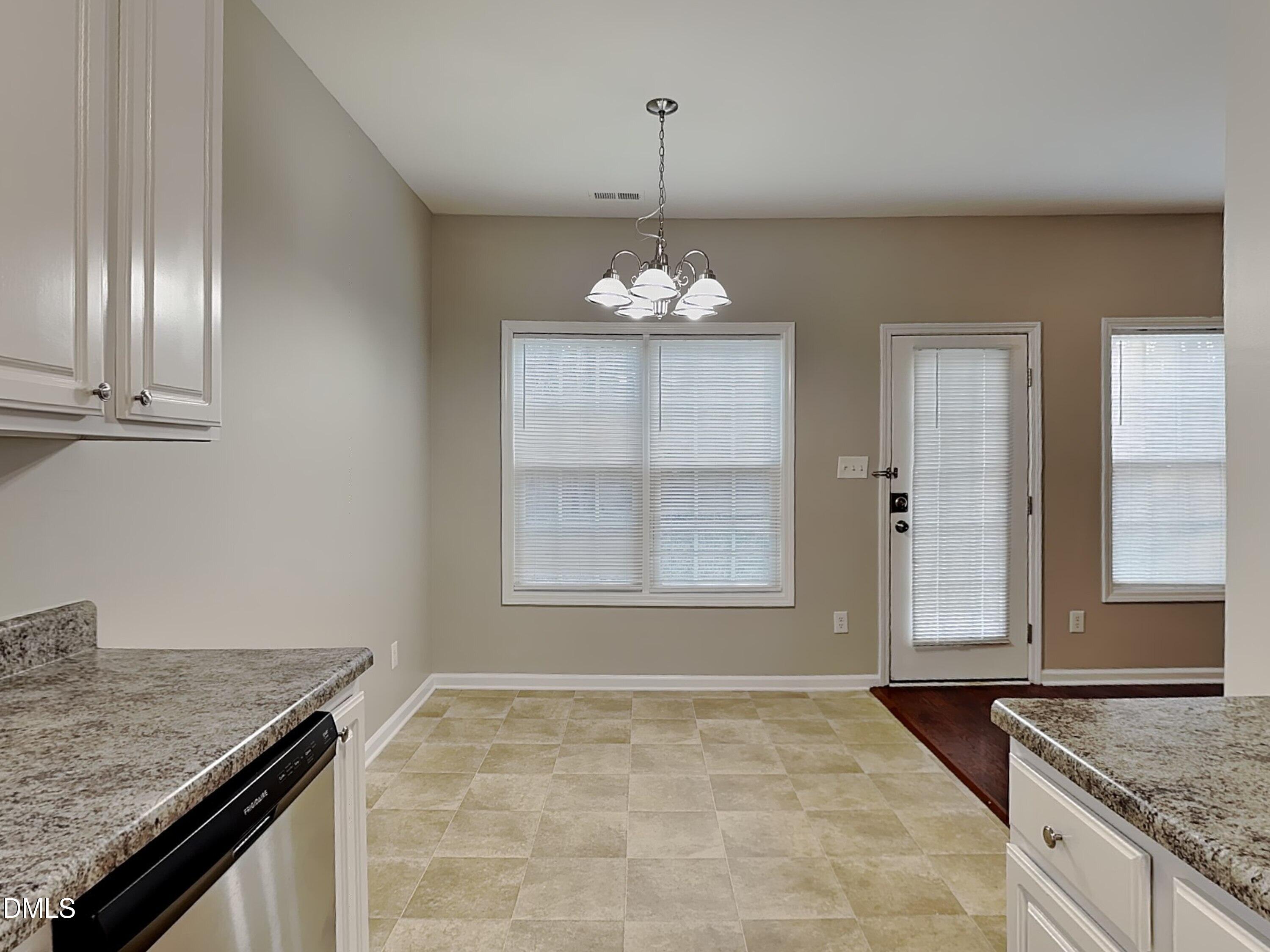4053 Laurel Glen Drive Raleigh, NC 27610 - Photo 7 of 20 an empty room with chandelier