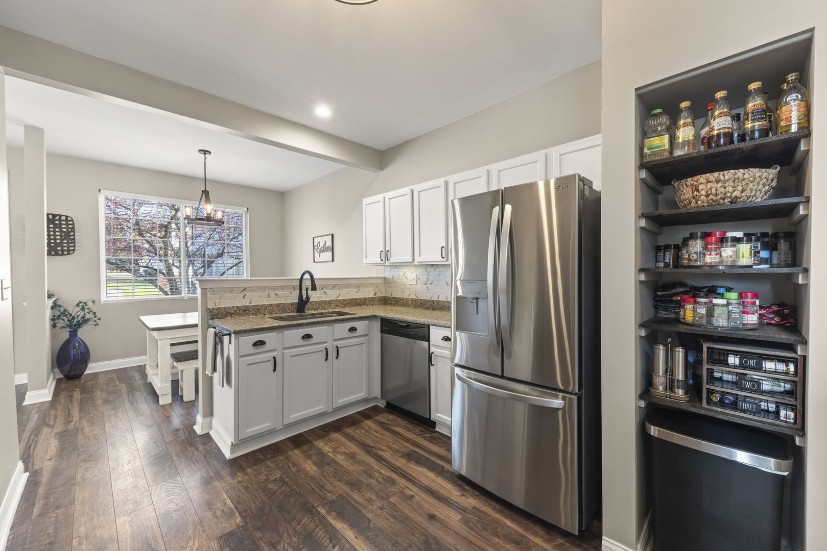 2263 Reflections Drive Aurora, IL 60502 - Photo 10 of 31 a kitchen with stainless steel appliances a refrigerator sink and wooden floor