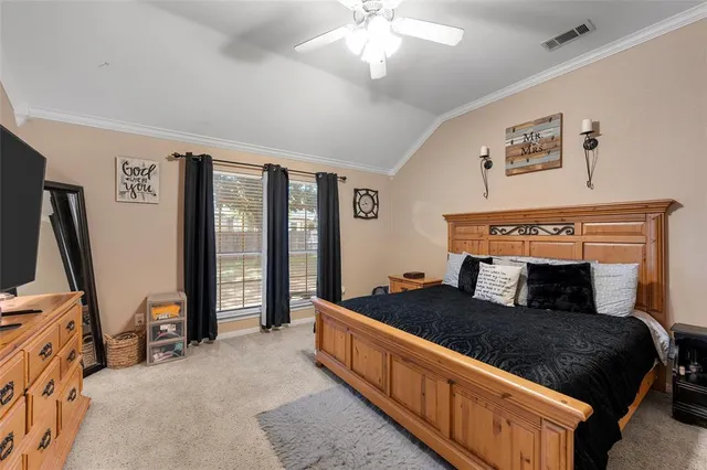 a bedroom with a large bed and flat tv screen