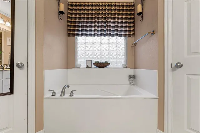 a bathroom with a bathtub and a shower