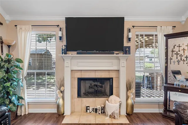 a living room with furniture a flat screen tv and a fireplace