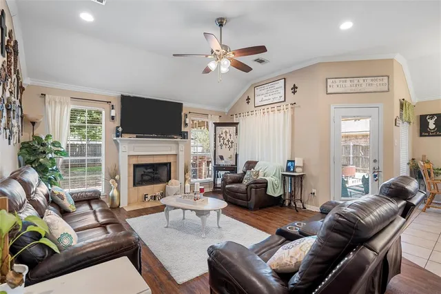 a living room with furniture fireplace and a large window