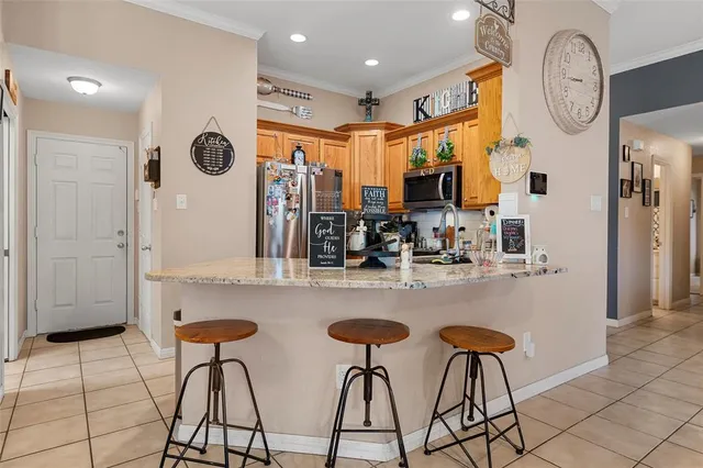 a kitchen with stainless steel appliances granite countertop a sink and a refrigerator