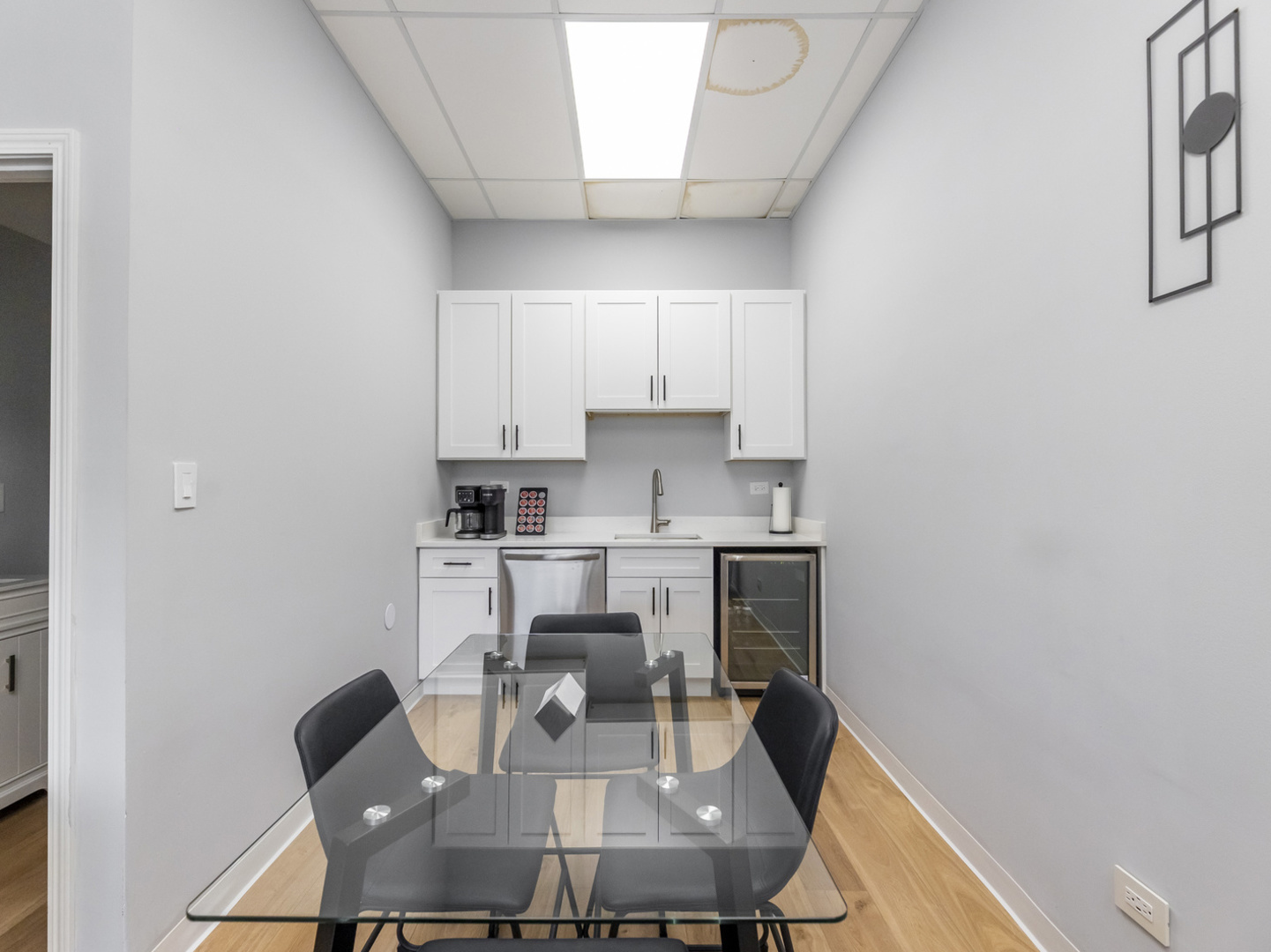5201 South Cornell Avenue, Unit 27D Chicago, IL 60615 - Photo 17 of 35 a kitchen with a dining table chairs and a refrigerator