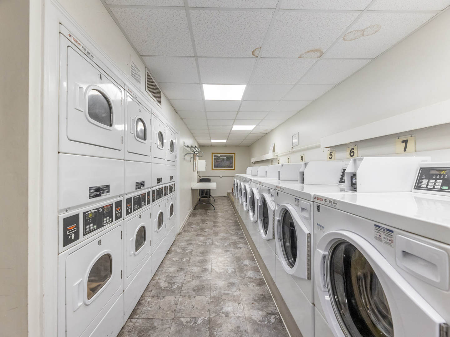 5201 South Cornell Avenue, Unit 27D Chicago, IL 60615 - Photo 19 of 35 a view of washer and dryer with kitchen in the background