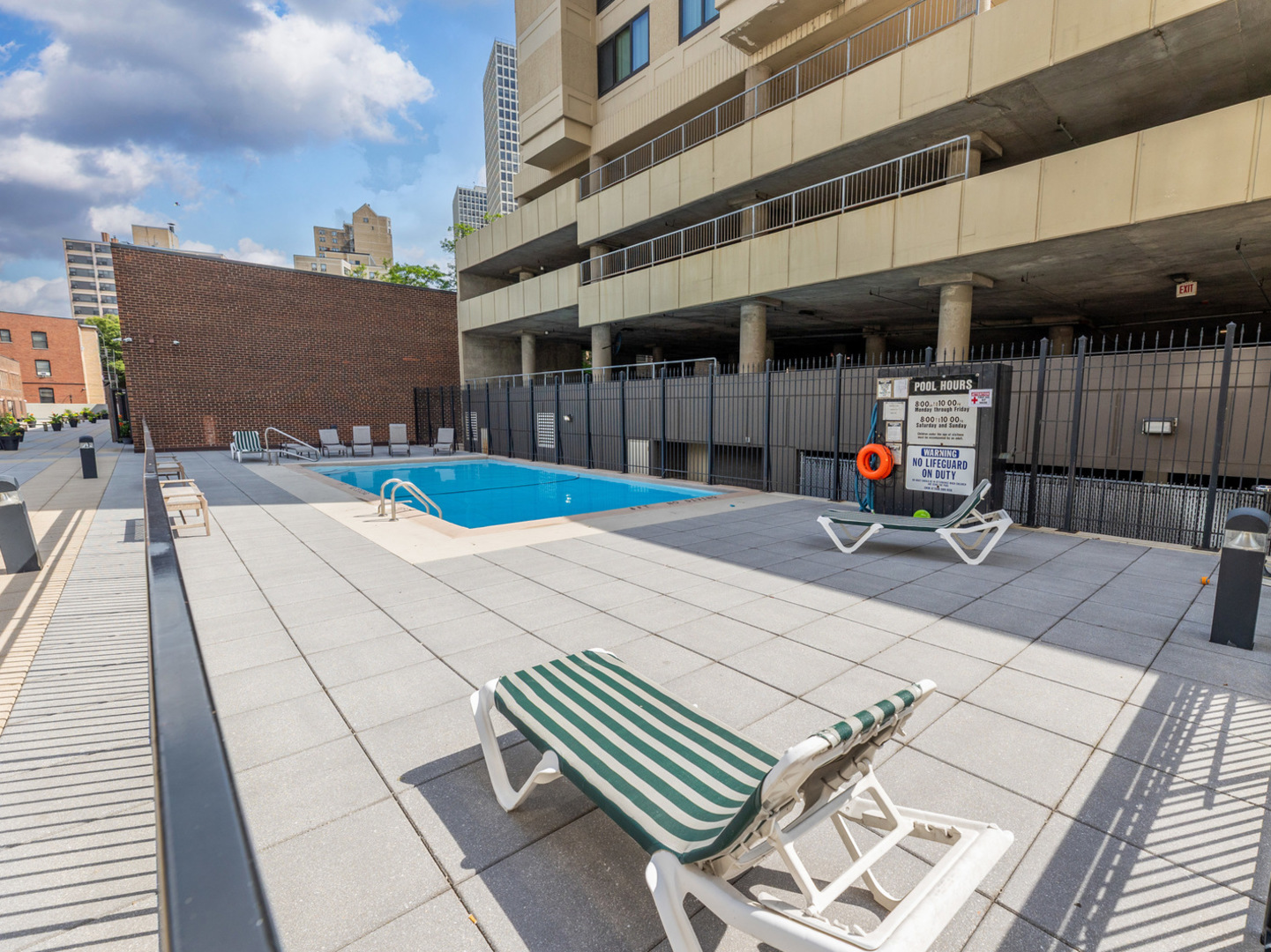 5201 South Cornell Avenue, Unit 27D Chicago, IL 60615 - Photo 20 of 35 a view of a patio with table and chairs with wooden floor and fence