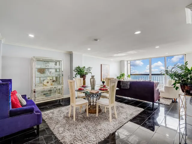 a living room with furniture a rug and a table