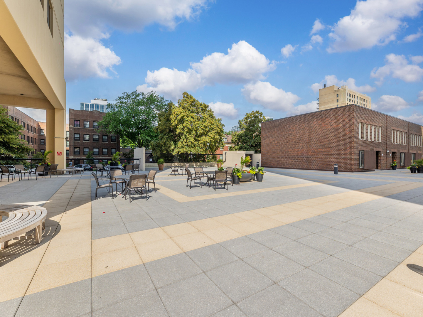 5201 South Cornell Avenue, Unit 27D Chicago, IL 60615 - Photo 22 of 35 a view of a patio with swimming pool and table and chairs