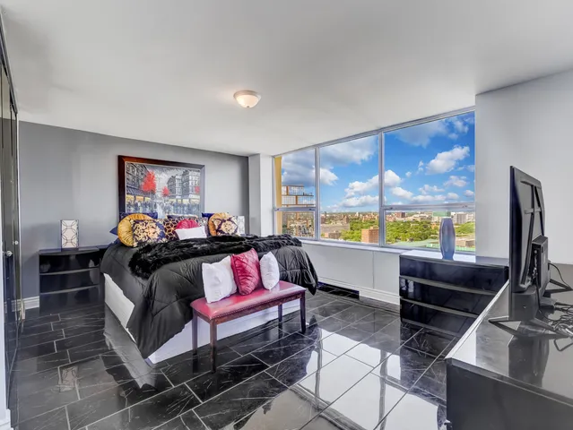 a bedroom with furniture and a flat screen tv