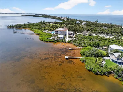 an aerial view of a houses with a lake view