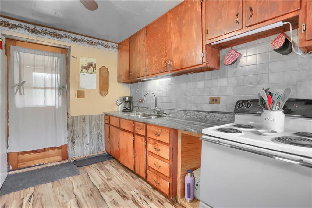 1204 Franklin Road Jackson Center, PA 16133 - Photo 20 of 26 a kitchen with stainless steel appliances granite countertop a sink stove and cabinets