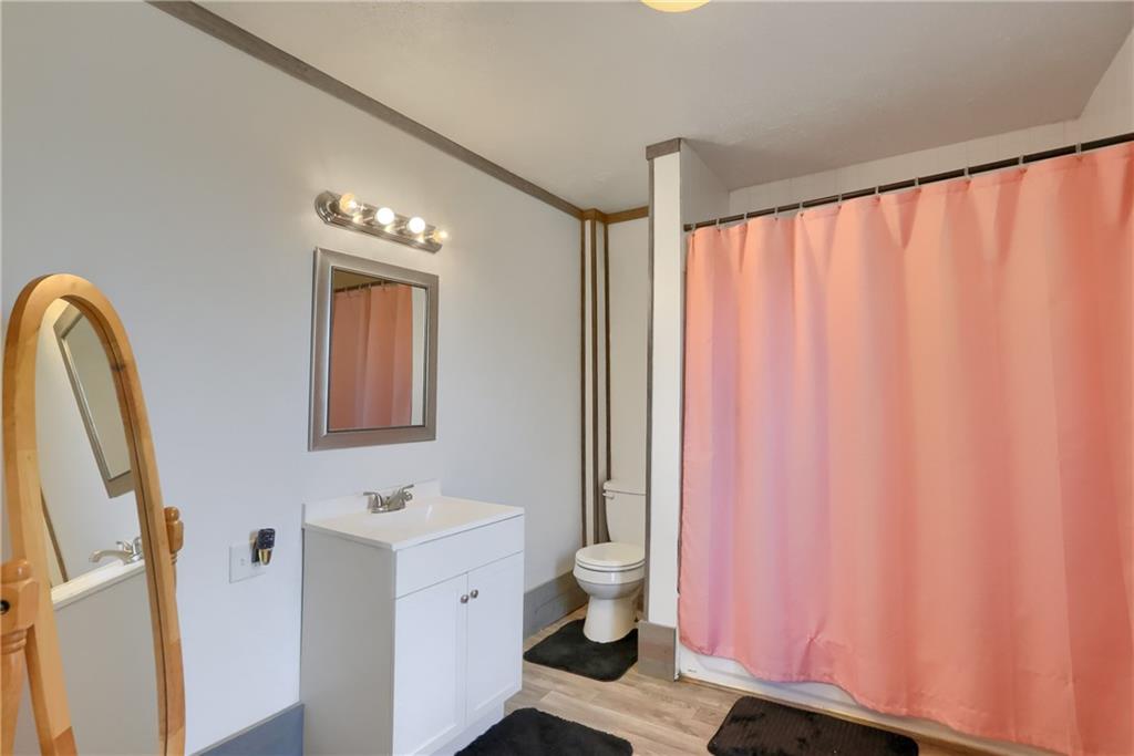 1204 Franklin Road Jackson Center, PA 16133 - Photo 21 of 26 a bathroom with a sink a toilet and a mirror