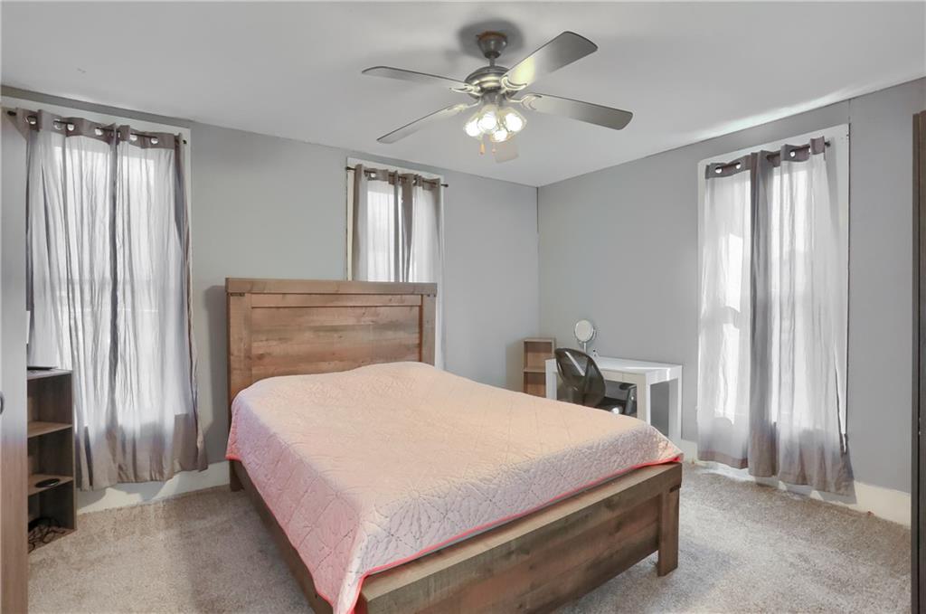 1204 Franklin Road Jackson Center, PA 16133 - Photo 24 of 26 a bedroom with a large bed and a chandelier