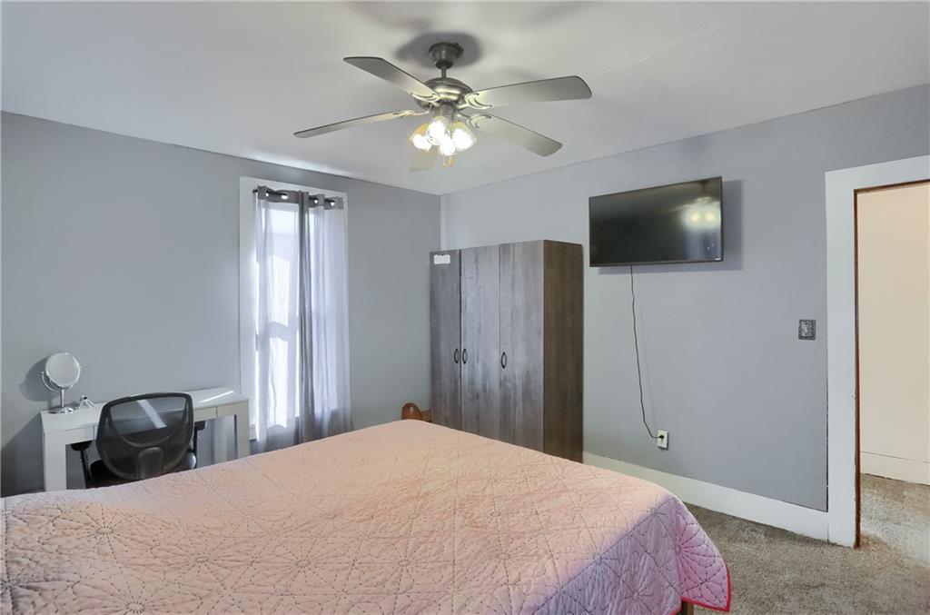1204 Franklin Road Jackson Center, PA 16133 - Photo 25 of 26 a bedroom with a bed and a chandelier