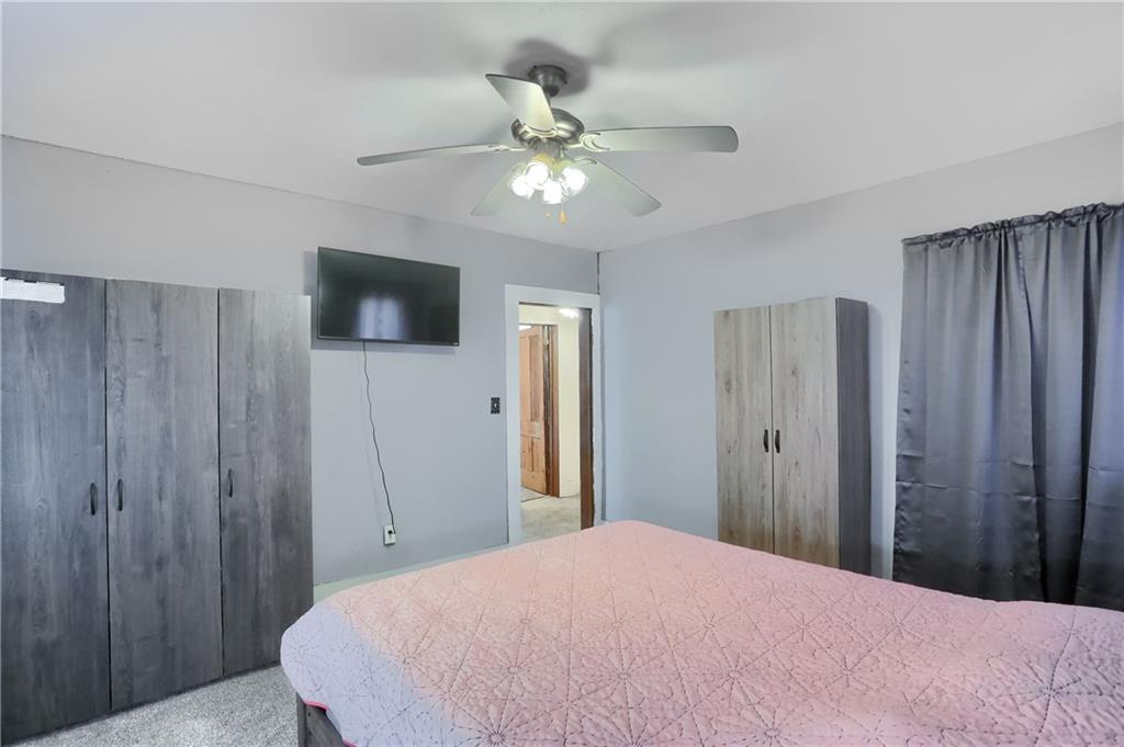 1204 Franklin Road Jackson Center, PA 16133 - Photo 26 of 26 a bedroom with a bed and a chandelier