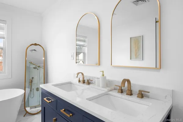 a bathroom with a granite countertop sink a toilet and a mirror