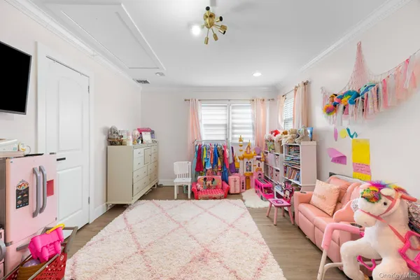 a bedroom with furniture and flat screen tv