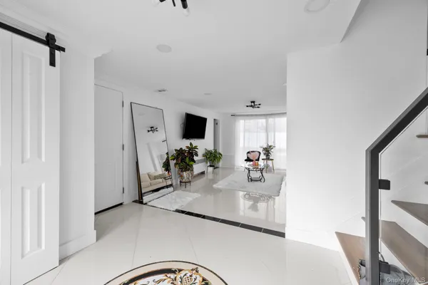 a dining room with furniture and a flat screen tv