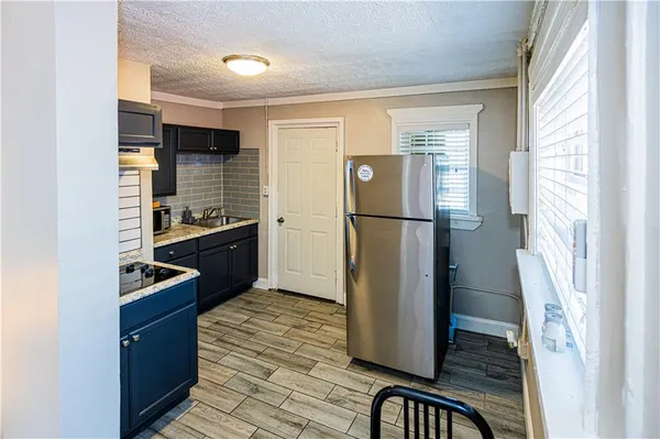 a kitchen with stainless steel appliances a refrigerator and a stove
