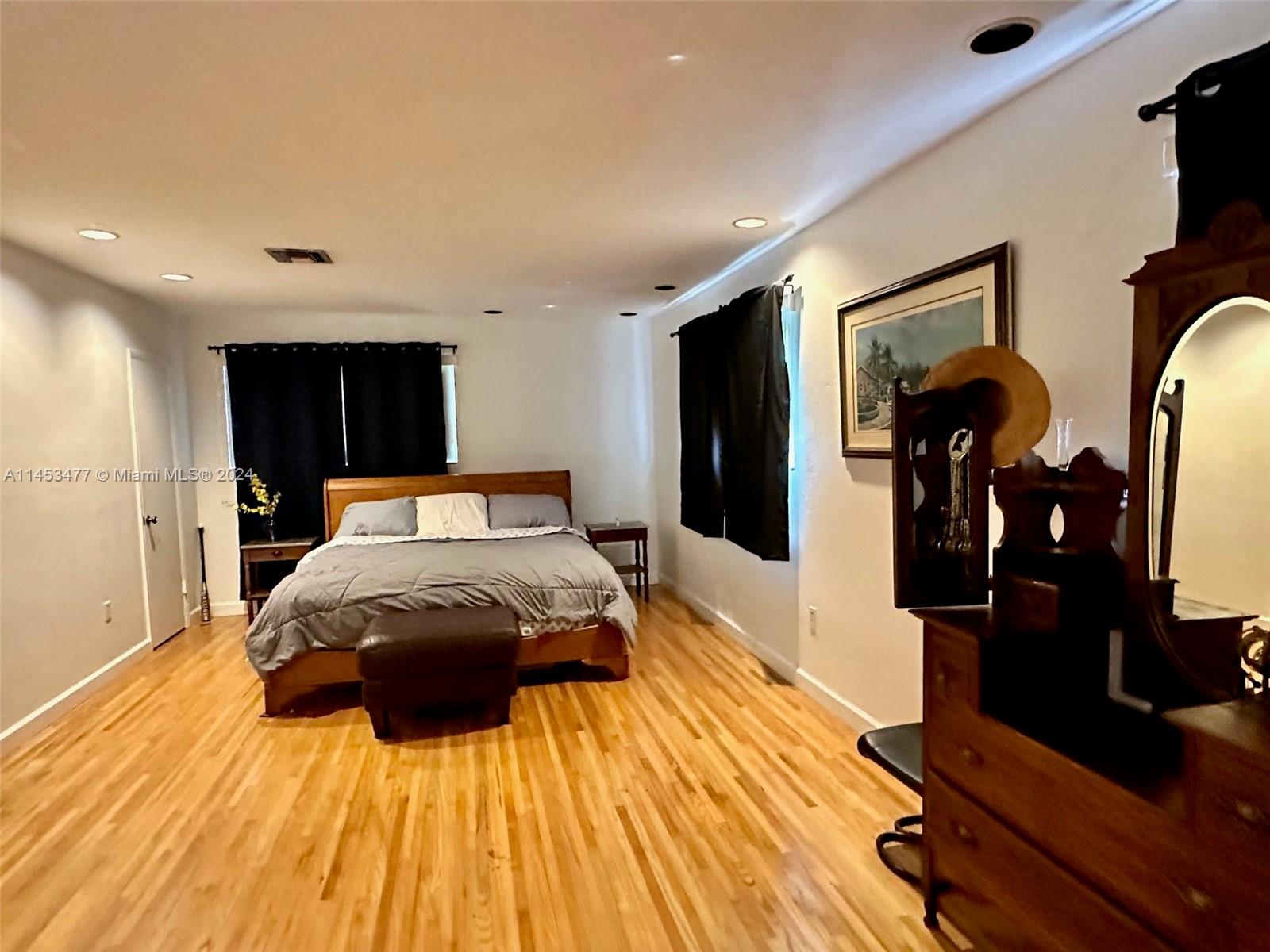 9320 Southwest 125th Terrace Miami, FL 33176 - Photo 15 of 31 a bedroom with a bed and wooden floor
