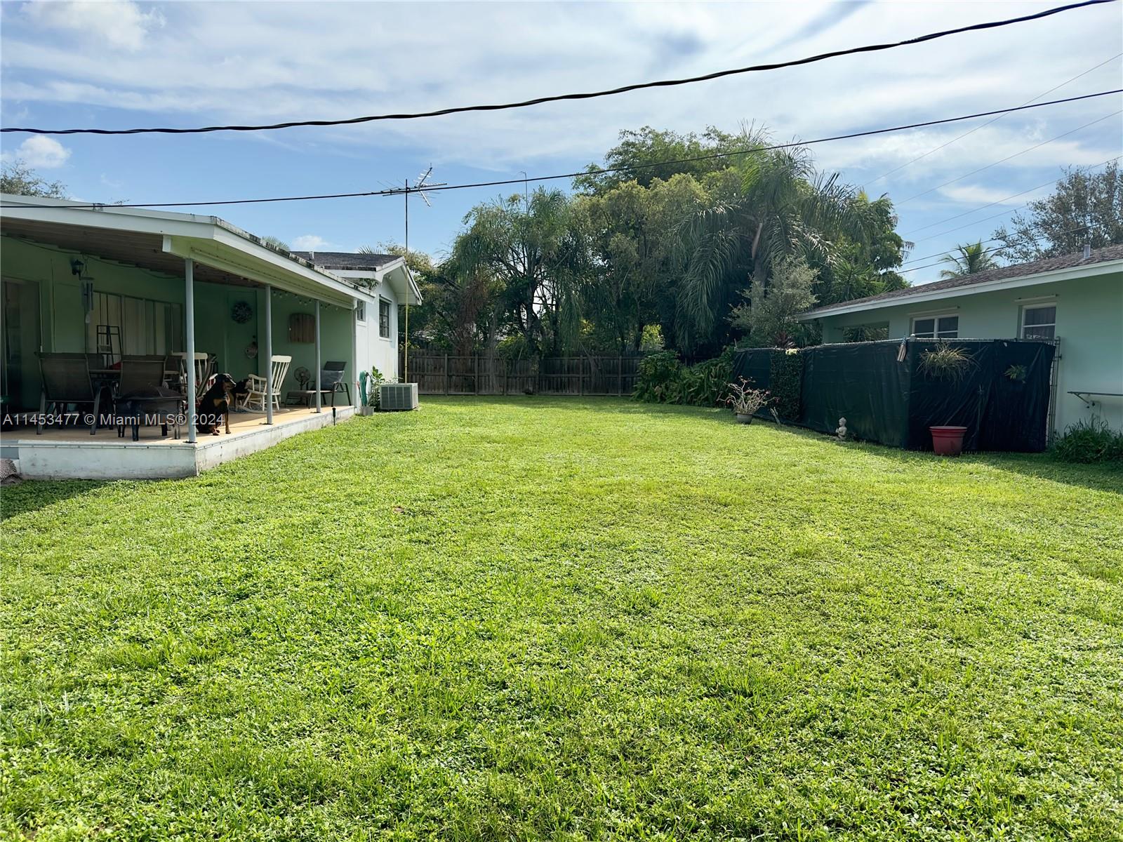 9320 Southwest 125th Terrace Miami, FL 33176 - Photo 19 of 31 a view of a house with a yard and furniture
