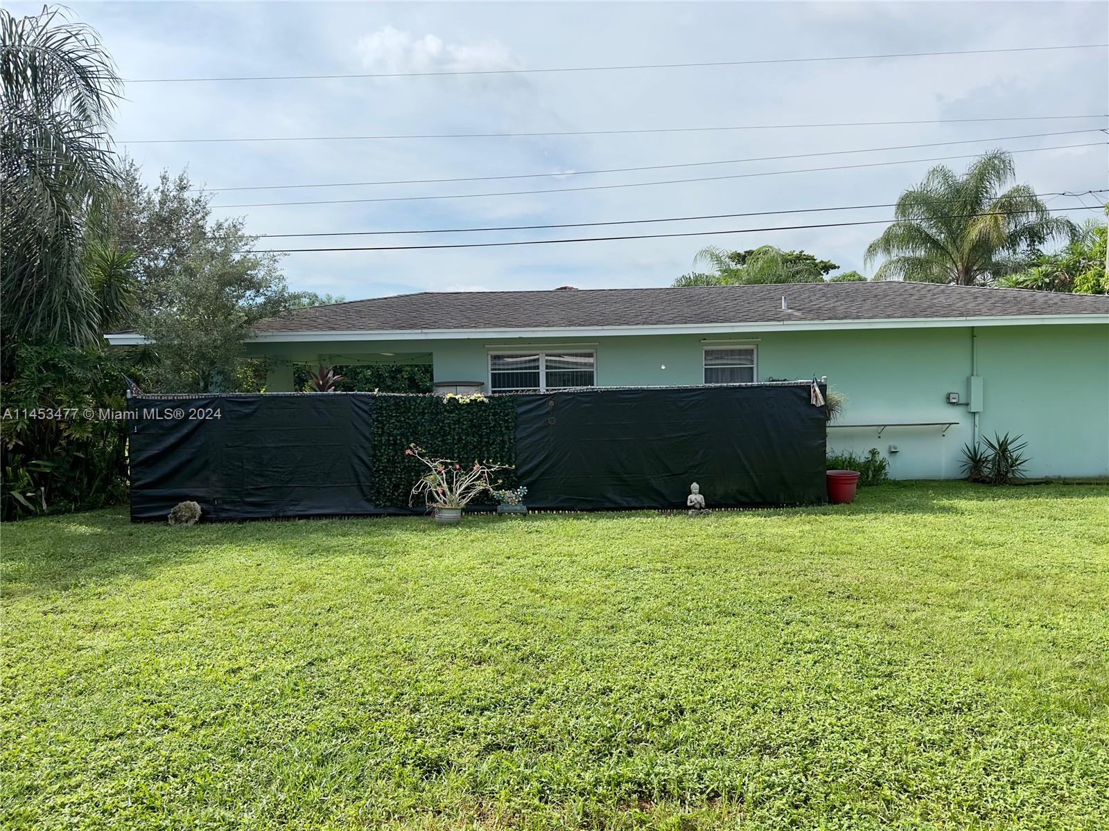 9320 Southwest 125th Terrace Miami, FL 33176 - Photo 20 of 31 a backyard of a house with lots of green space and outdoor seating