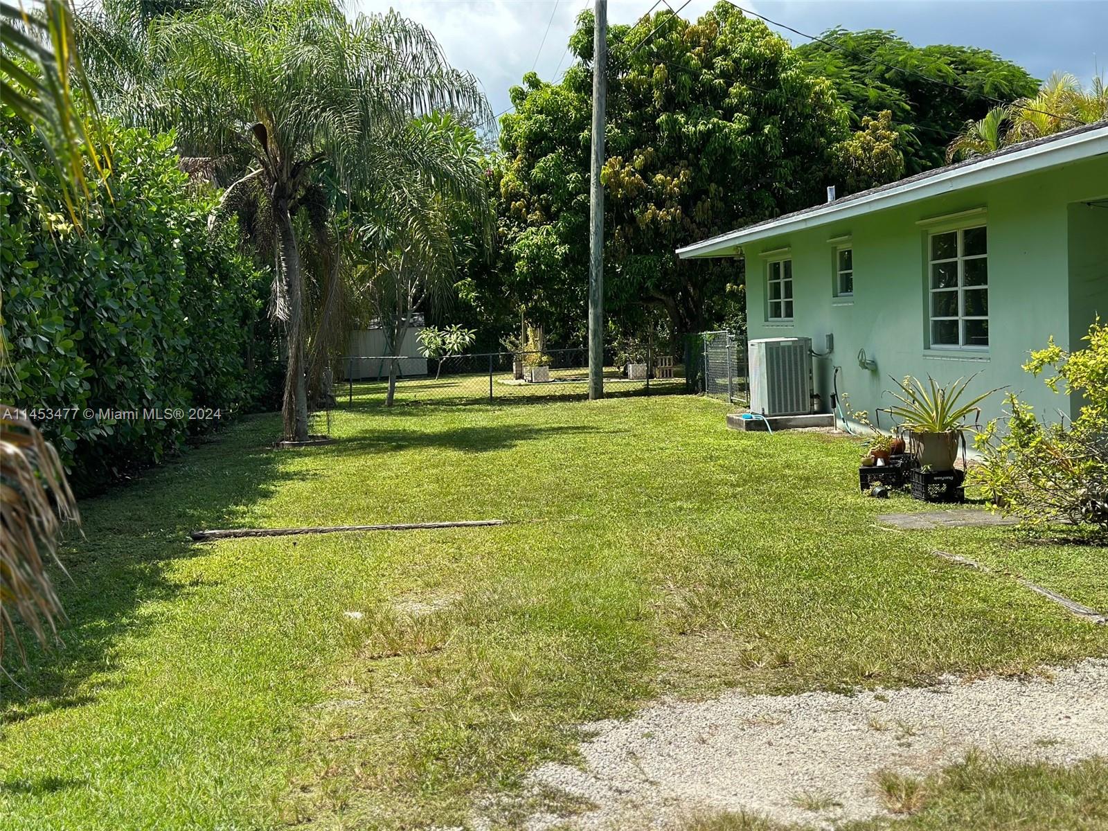 9320 Southwest 125th Terrace Miami, FL 33176 - Photo 22 of 31 a view of a house with a yard