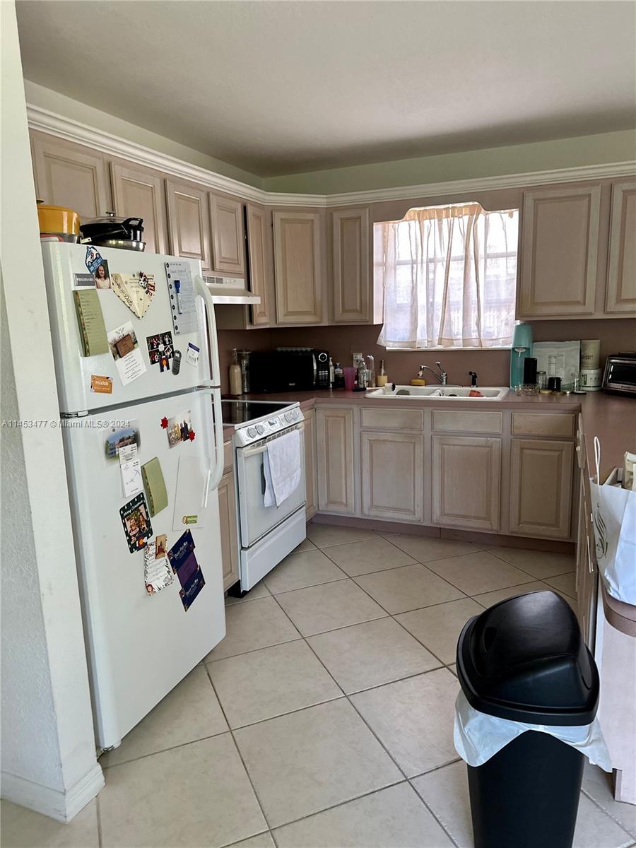 9320 Southwest 125th Terrace Miami, FL 33176 - Photo 24 of 31 a kitchen with stainless steel appliances a stove a sink and a refrigerator