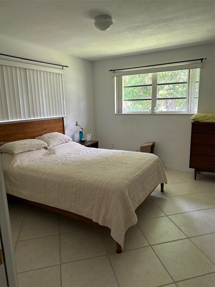 9320 Southwest 125th Terrace Miami, FL 33176 - Photo 26 of 31 a bedroom with a bed and a window