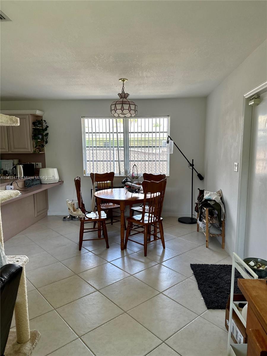 9320 Southwest 125th Terrace Miami, FL 33176 - Photo 30 of 31 a view of a dining room with furniture and a window