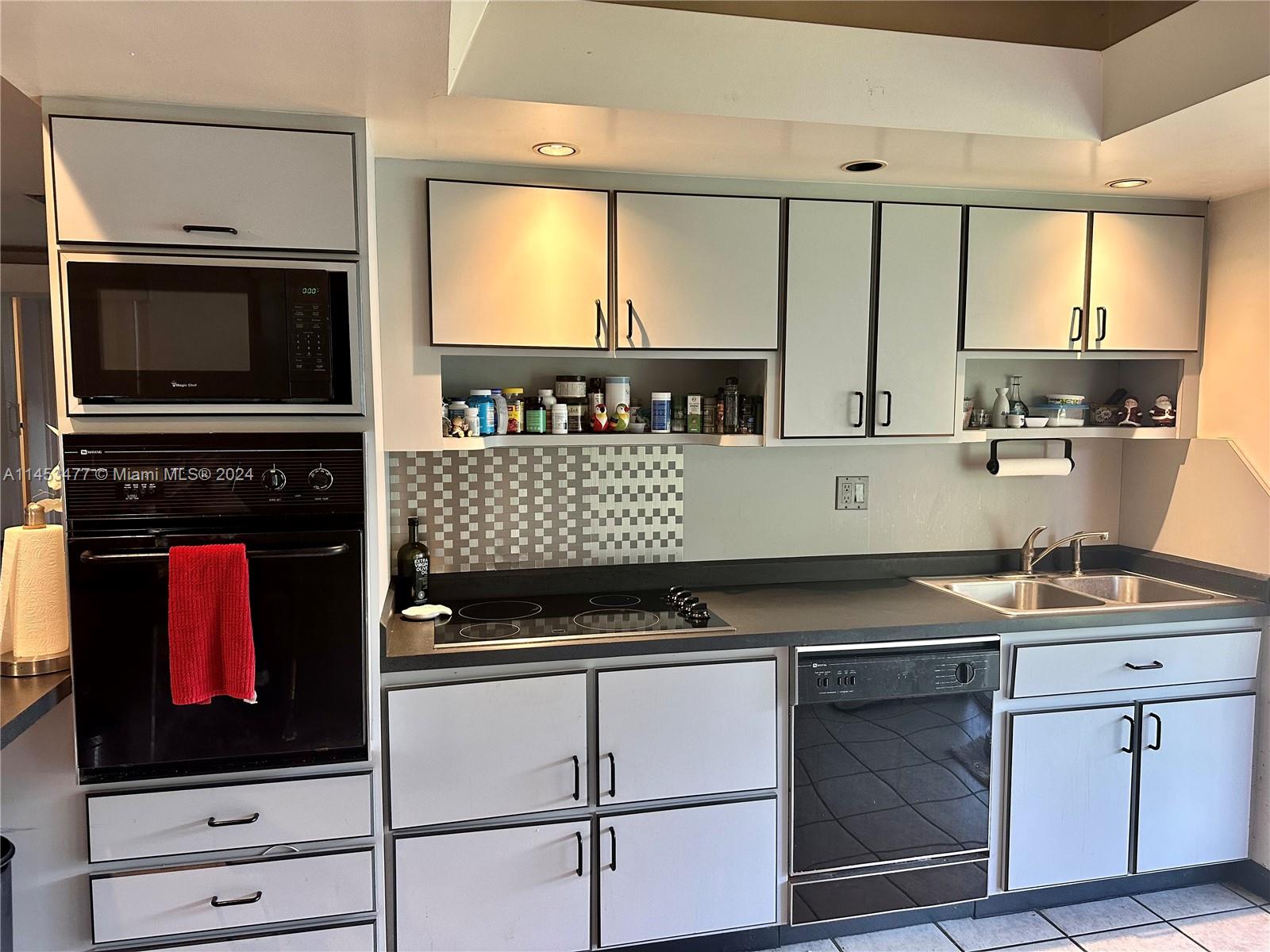 9320 Southwest 125th Terrace Miami, FL 33176 - Photo 6 of 31 a kitchen with a stove and a microwave