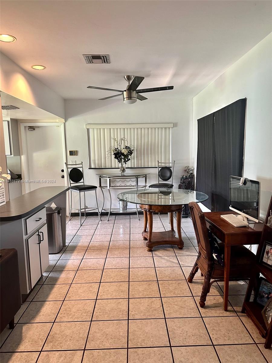 9320 Southwest 125th Terrace Miami, FL 33176 - Photo 7 of 31 a open kitchen with stainless steel appliances kitchen island granite countertop a sink a stove a dining table and chairs