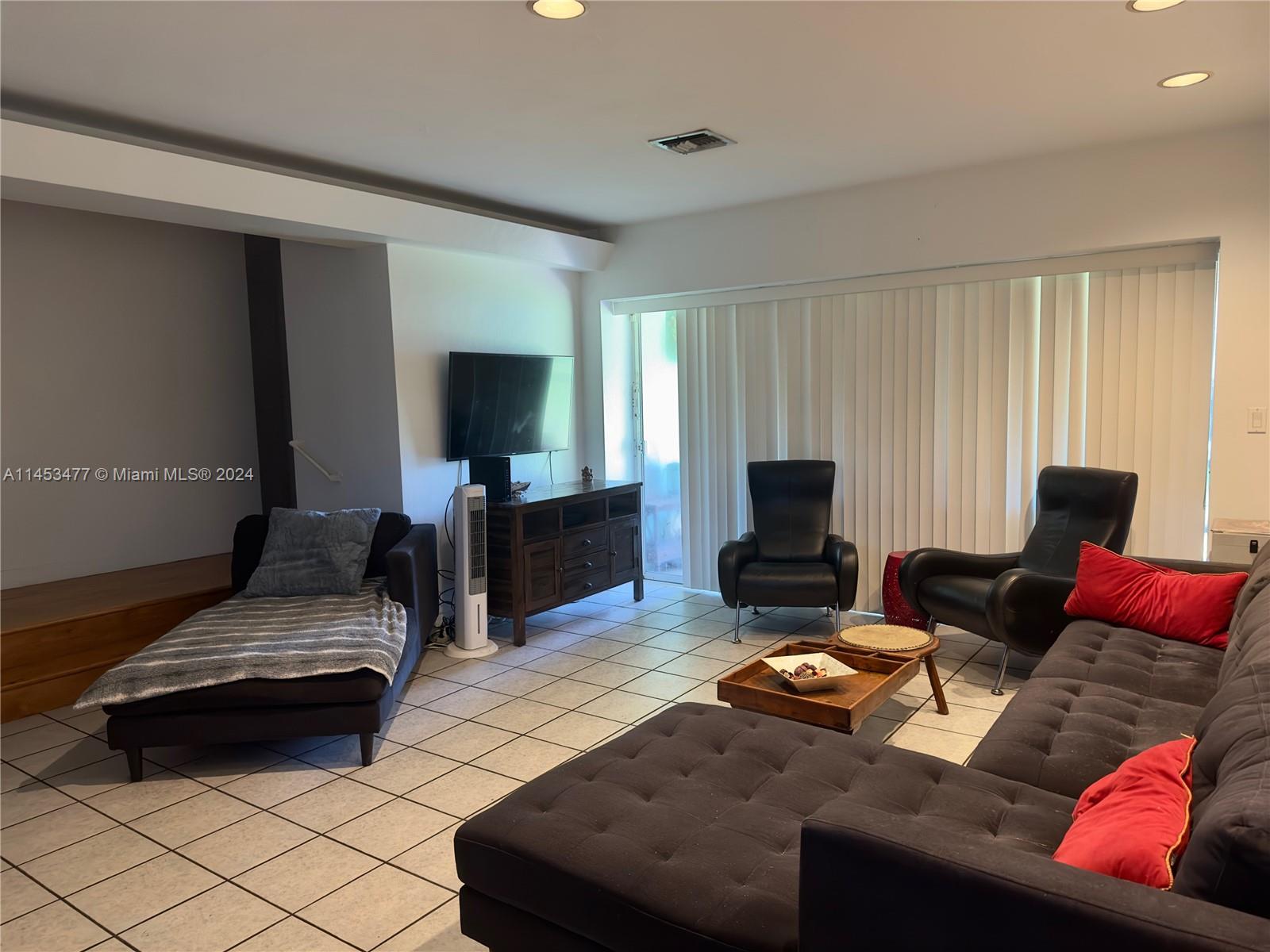 9320 Southwest 125th Terrace Miami, FL 33176 - Photo 9 of 31 a living room with furniture and a flat screen tv