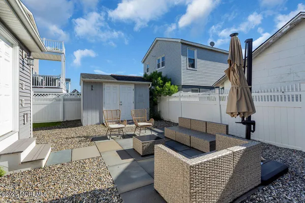 a view of a couches and dinning table in patio