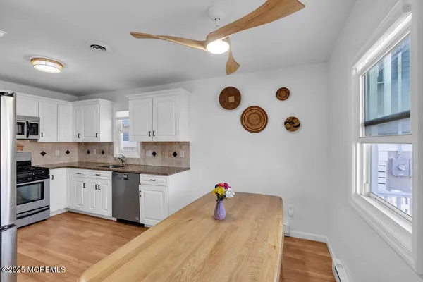 a kitchen with cabinets a sink and appliances