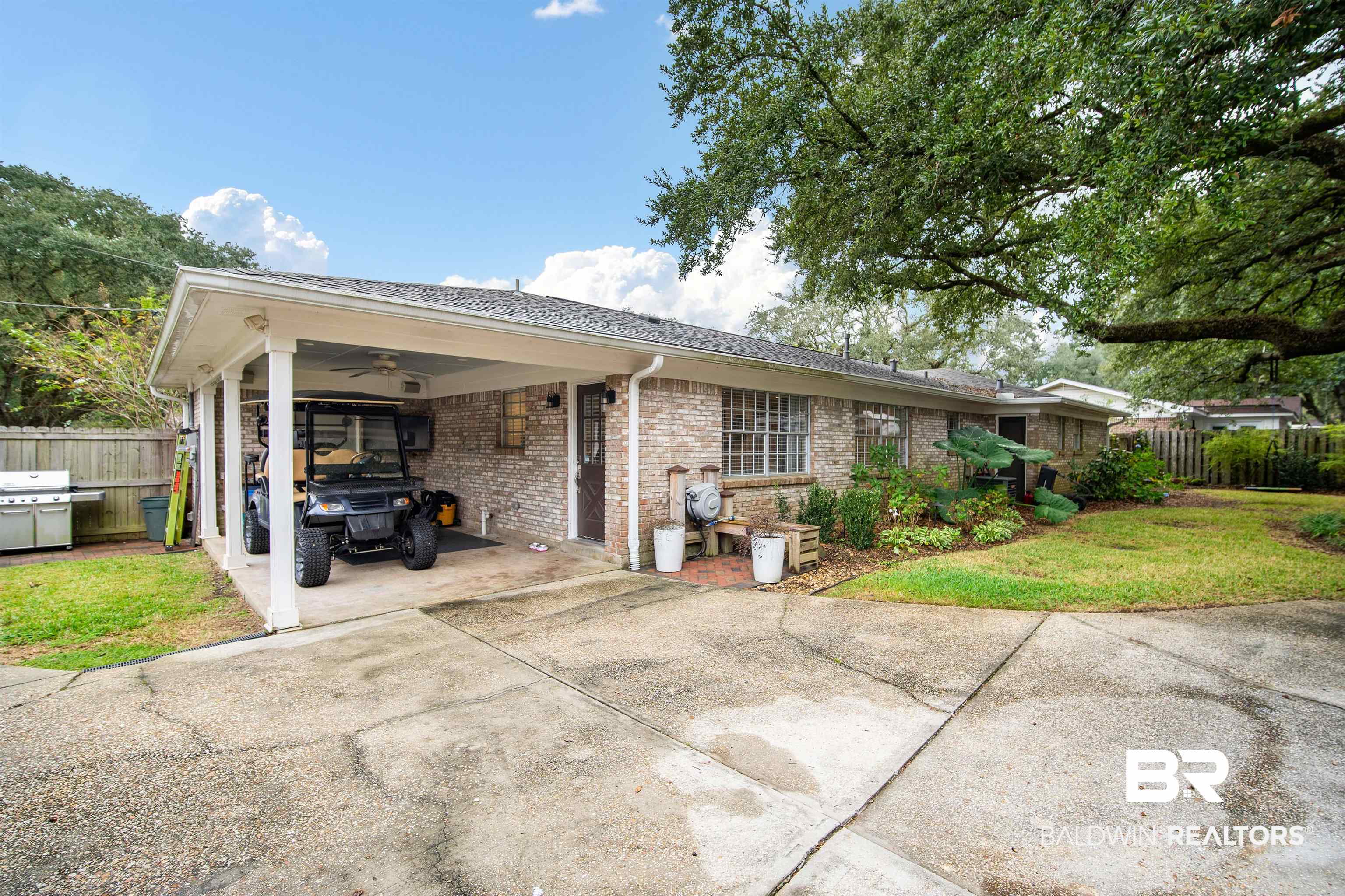 4228 Spring Valley Drive South Mobile, AL 36693 - Photo 29 of 31 Ranch-style house featuring a carport and a front lawn
