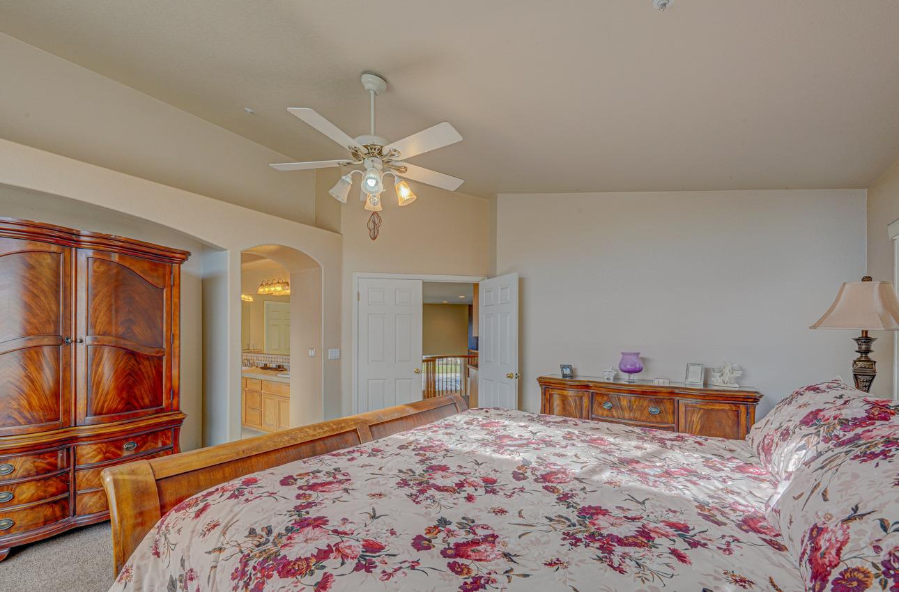 2 Whitman Circle Salinas, CA 93906 - Photo 29 of 41 a bedroom with a bed and a chandelier
