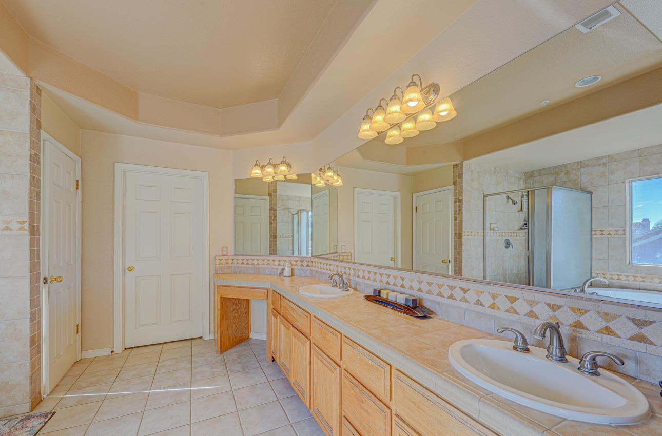 2 Whitman Circle Salinas, CA 93906 - Photo 30 of 41 a bathroom with a double vanity sink mirror and a bathtub