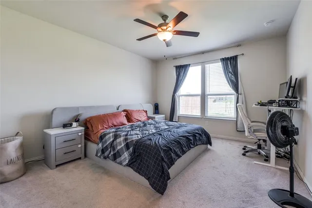 a bed room with a bed and a chair