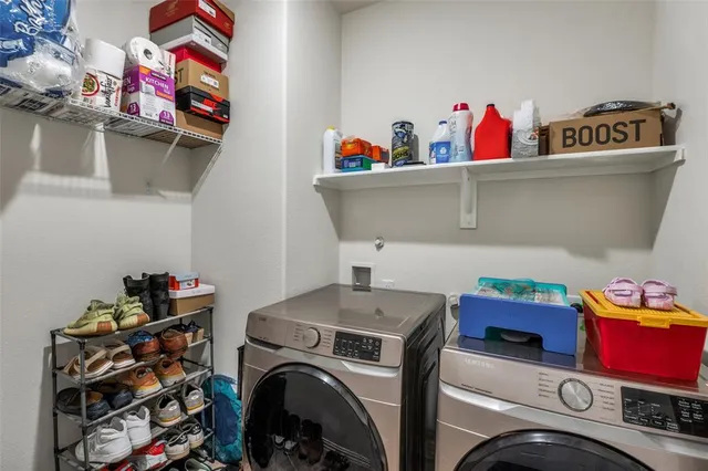a utility room with dryer washer and shoe rack