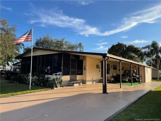 a view of a house with backyard porch and sitting area