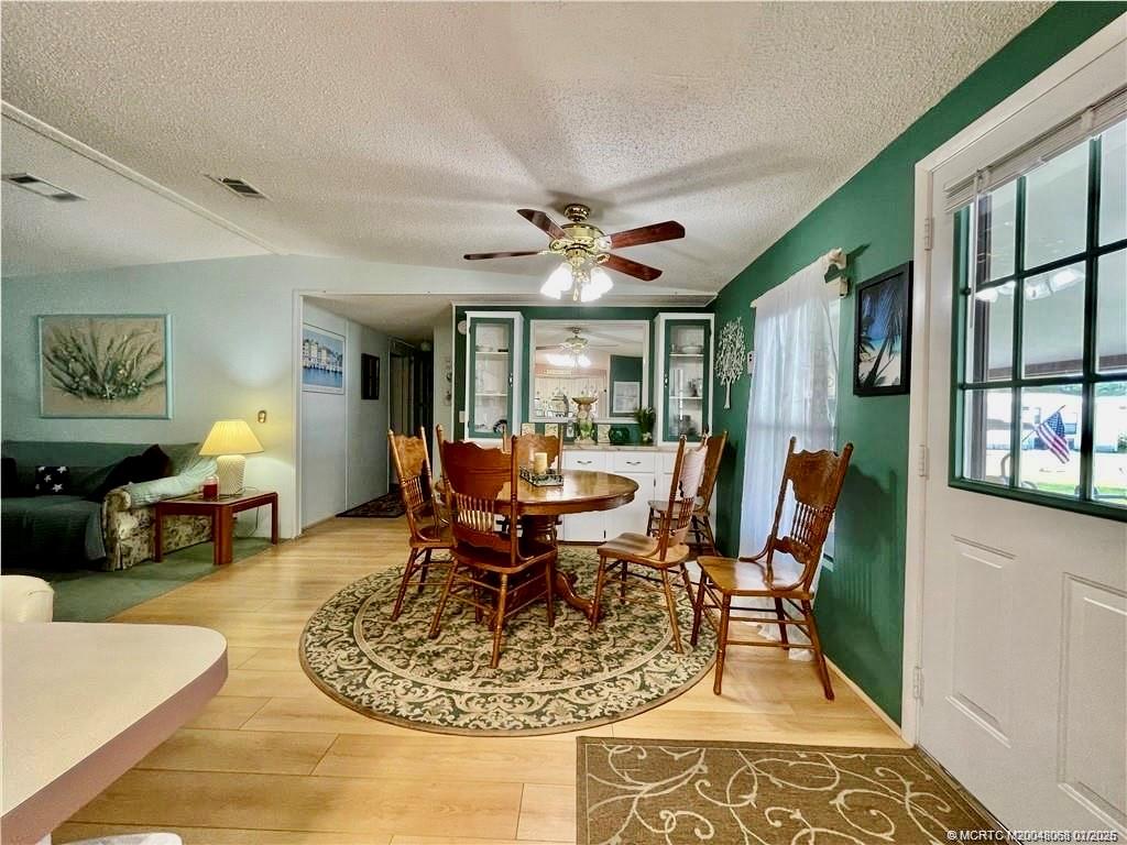 16236 Southwest Three Wood Way Indiantown, FL 34956 - Photo 12 of 26 a living room with furniture and a large window