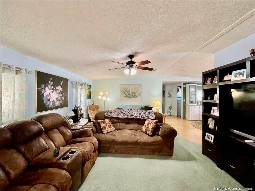 16236 Southwest Three Wood Way Indiantown, FL 34956 - Photo 13 of 26 a living room with furniture and a flat screen tv