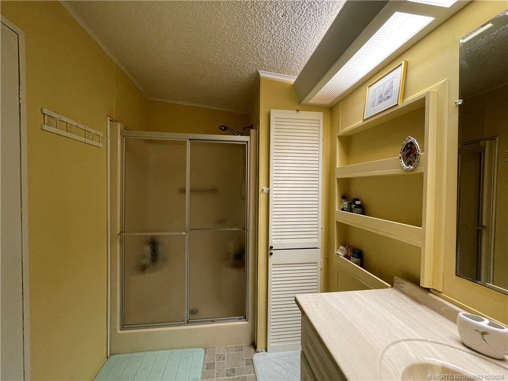 16236 Southwest Three Wood Way Indiantown, FL 34956 - Photo 14 of 26 a bathroom with a tub and a shower