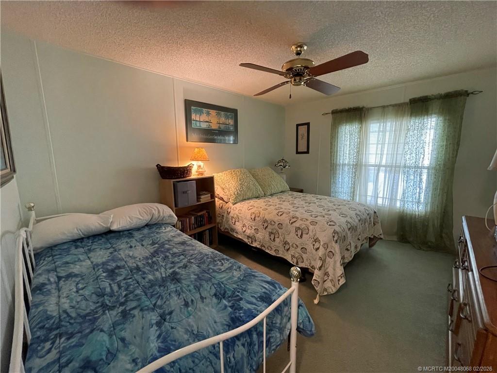 16236 Southwest Three Wood Way Indiantown, FL 34956 - Photo 16 of 26 a bedroom with double bed and a window