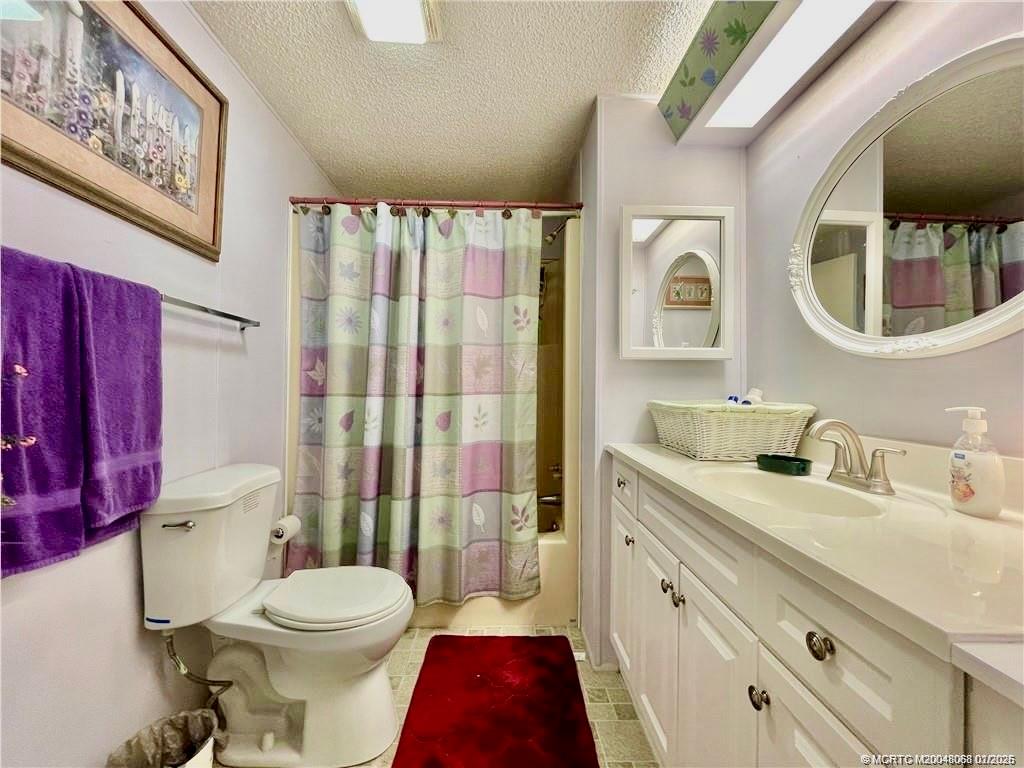 16236 Southwest Three Wood Way Indiantown, FL 34956 - Photo 17 of 26 a bathroom with a toilet a sink and a mirror